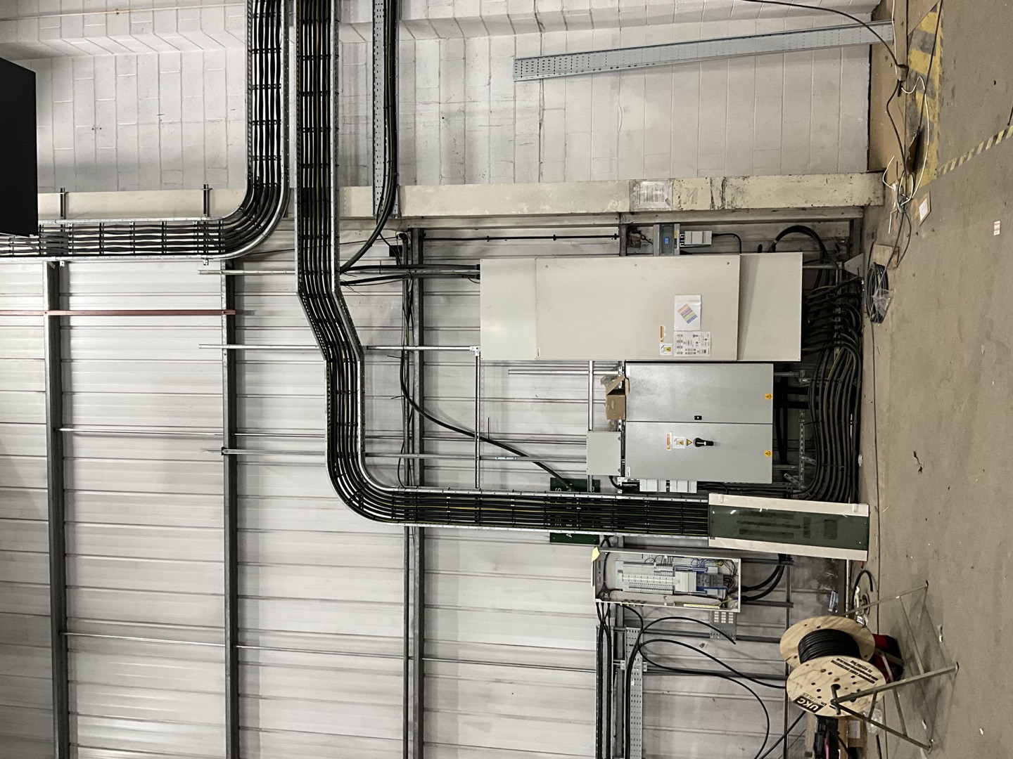 Organised industrial cable routes feeding electrical distribution panels